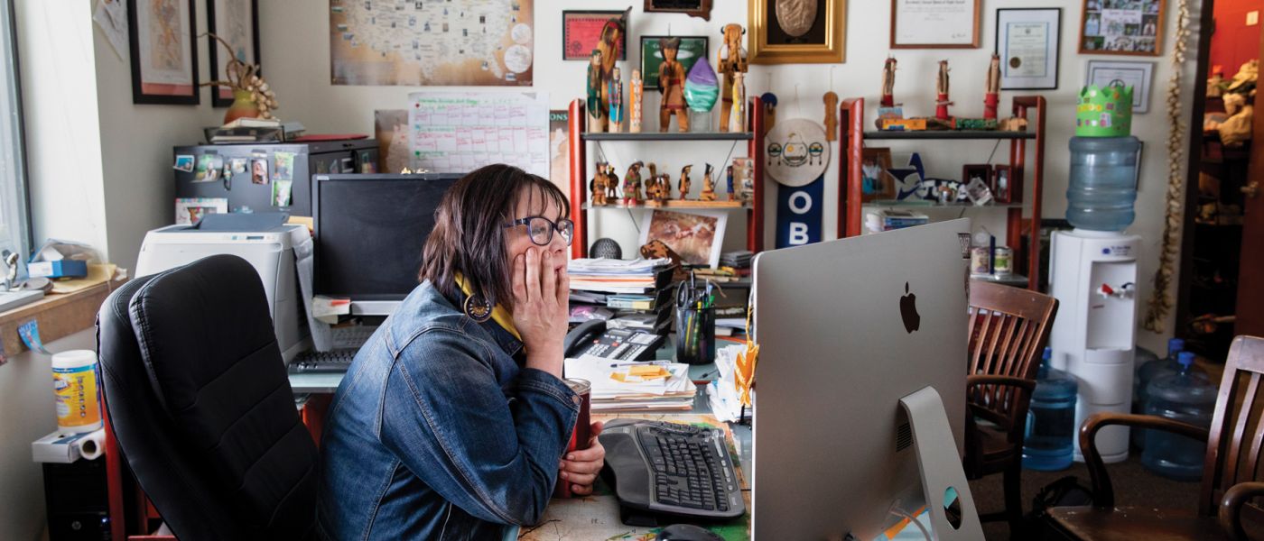 Julie Garreau at her desk looking at her computer