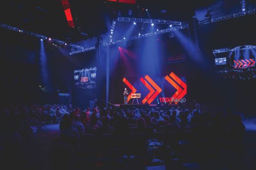 Emcee Greg Tehven welcomes more than 2,000 attendees to  the 10th TEDxFargo event in Fargo, North Dakota.