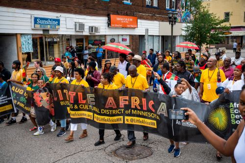 People marching with a banner for AEDS event