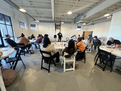 Breakout session showing people at tables at NextGen